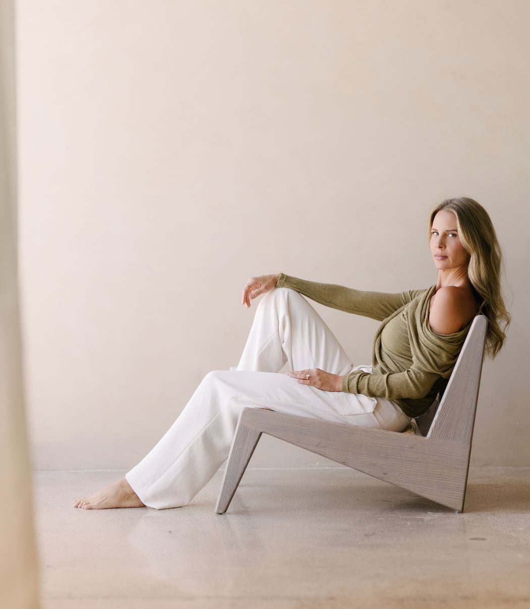 Elle Wilk seated in a sculptural chair